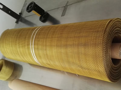 A roll of brass wire mesh is placed on table.