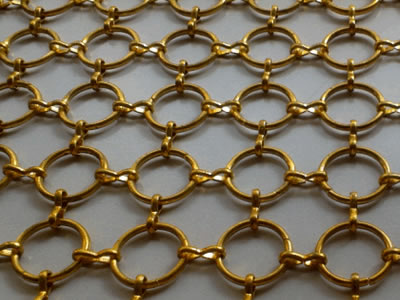 The picture shows a piece of brass coated S hook ring mesh.
