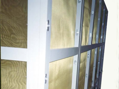 The picture shows brass wire cloth installed in white wood frames.