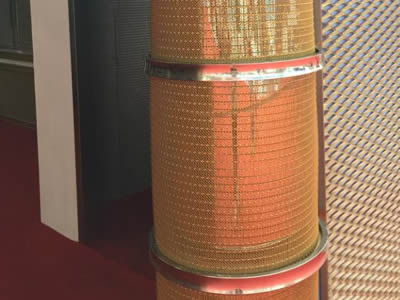 Brass weave decorative mesh is installed as a light post outside the factory hall.