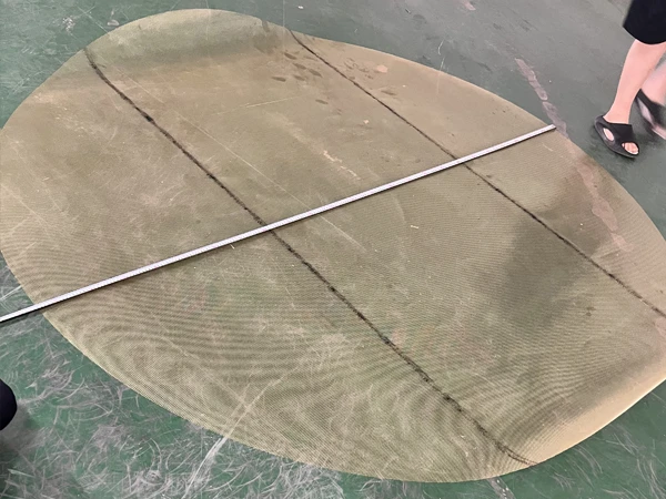 Two people in profile view of the brass expanded metal mesh circular sample's diameter