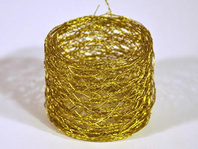 Golden brass hexagonal mesh roll in the form of narrow but long.