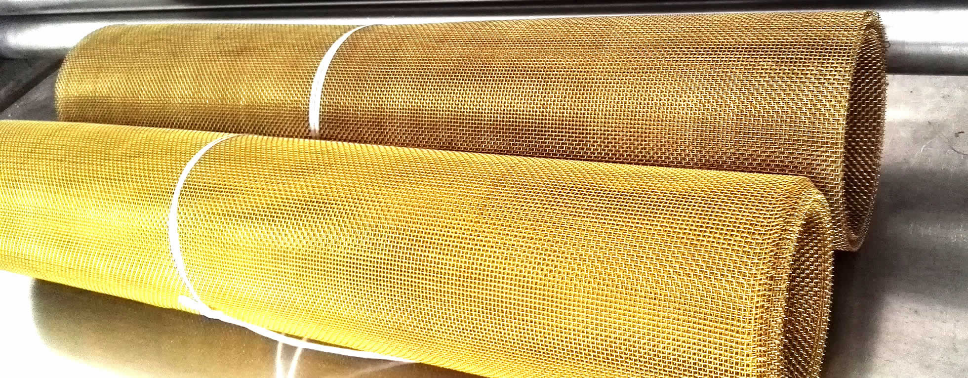 Two brass wire mesh rolls is bundled by white rope.