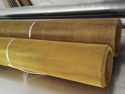 Two brass wire mesh rolls is bundled by white rope.
