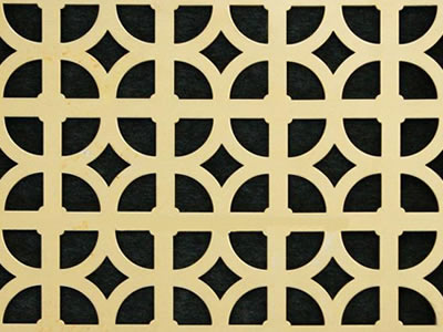 The picture shows a piece of circle plus cross brass perforated mesh with black background.