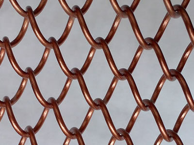 The picture shows a piece of copper coated metal mesh curtain.