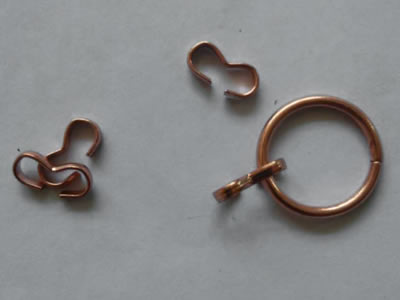 The picture shows a copper coated ring and four S hooks.