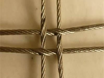 A piece of stainless steel square cable mesh with cross-shaped structure.