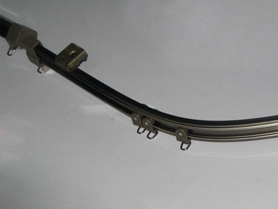 The picture shows curved H track with plugs and pulleys.