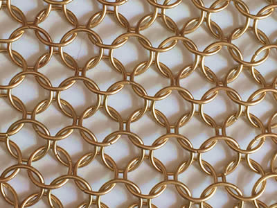 This is a woven brass chain mail decorative mesh.