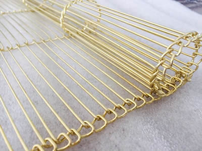 A woven brass decorative conveyor belt curtain mesh.