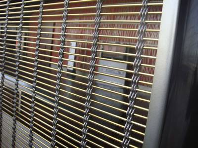 Facade mesh with stainless steel ropes and brass rods is installed in the office.