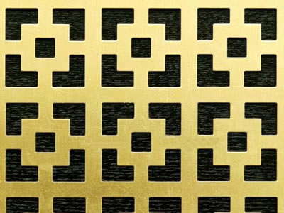 The picture shows a piece of large small square brass perforated mesh.