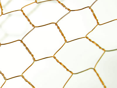 Golden reverse twist bronze hexagonal mesh with big holes.