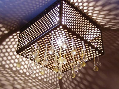 Round perforated mesh with crystal falls around the light.